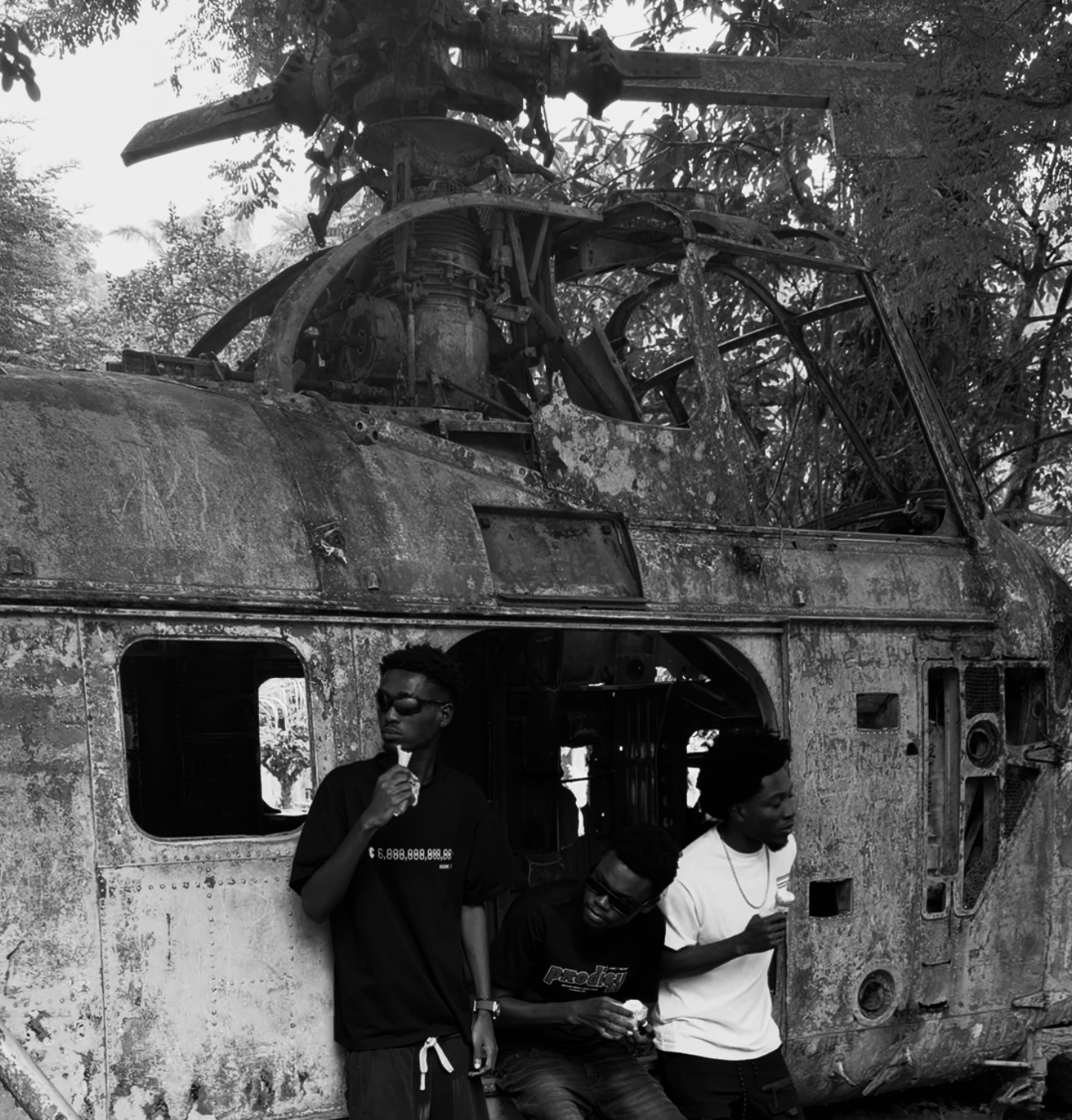 MONOKROME campaign group portrait beside a damaged helicopter